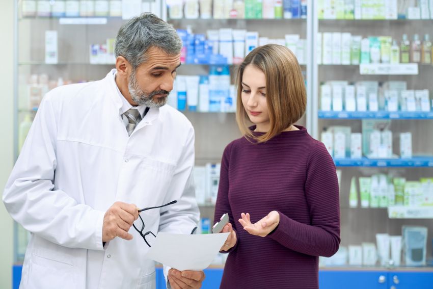 chemist explaining prescription woman drugstore