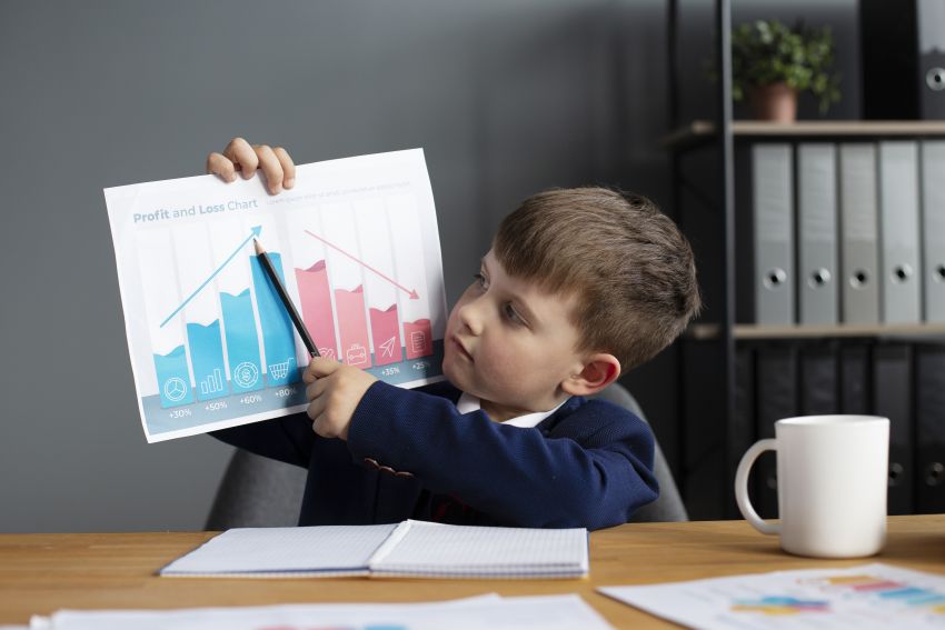 cute boy showing graph his office desk 