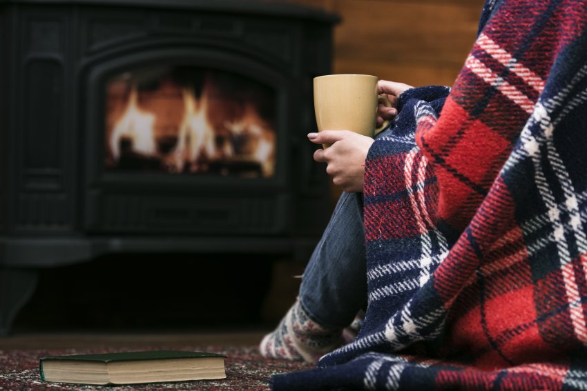 fire and woman covered blanket