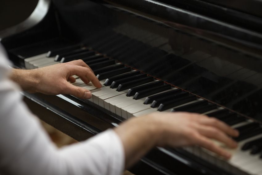 high angle hands playing piano 