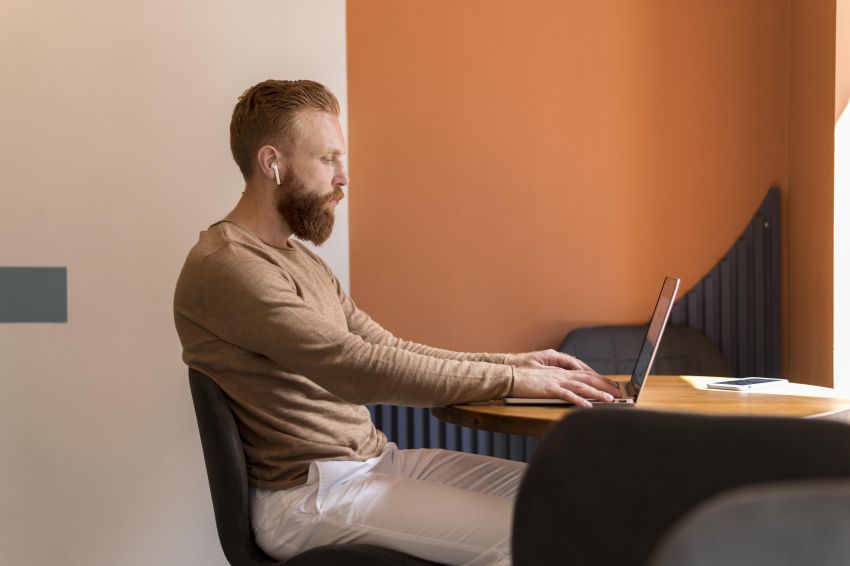 man sitting in front of laptop 