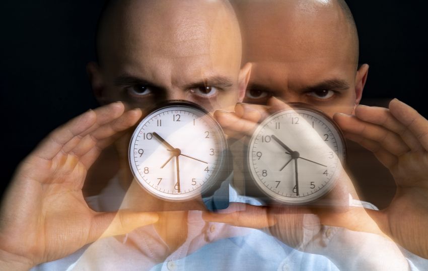 man with two clocks in front