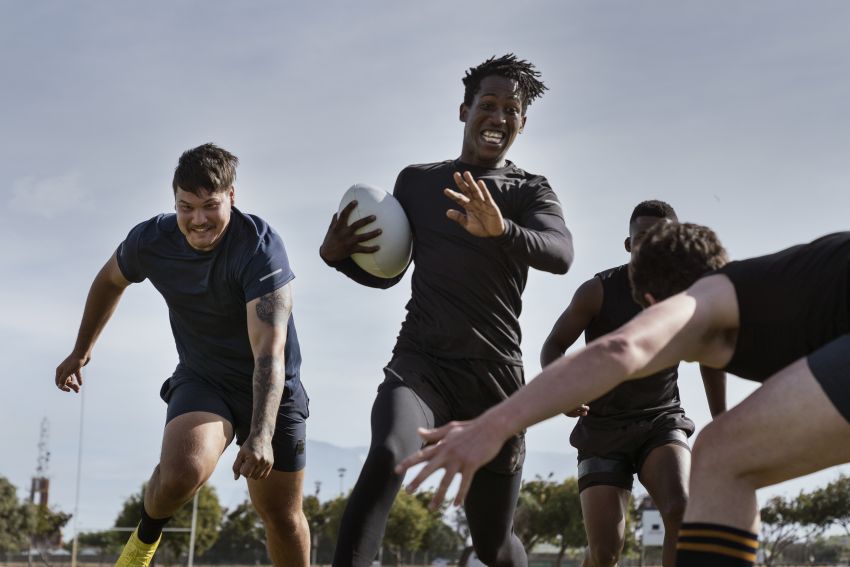 men playing rugby field 