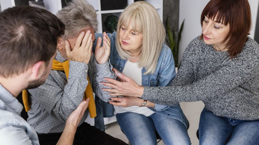 people comforting desperate woman 