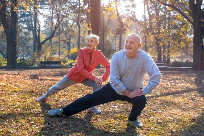 senior couple exercising park 