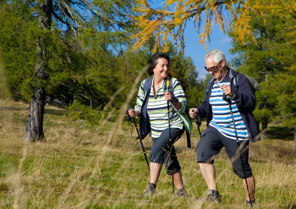 two seniors walking uphill