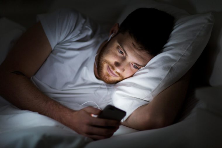 watching phone in bed